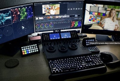 A computer workspace with three monitors for video editing in DaVinci.